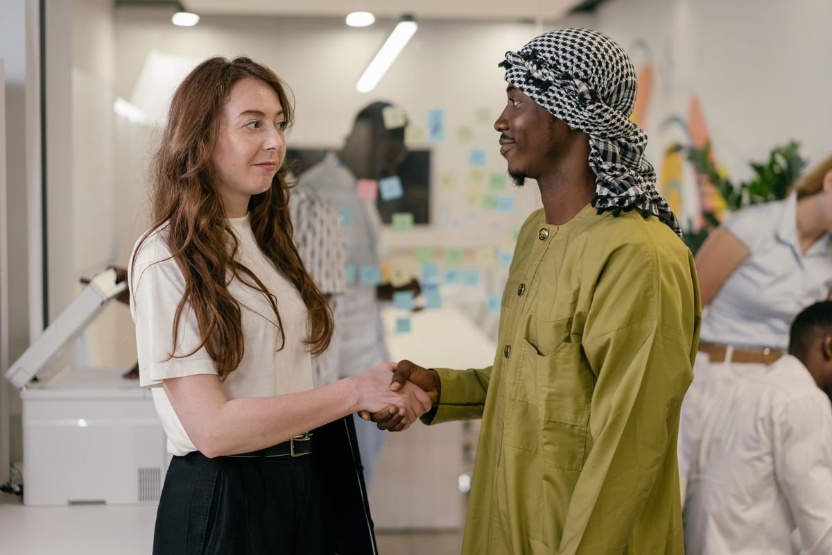 Two colleagues from different backgrounds shaking hands
